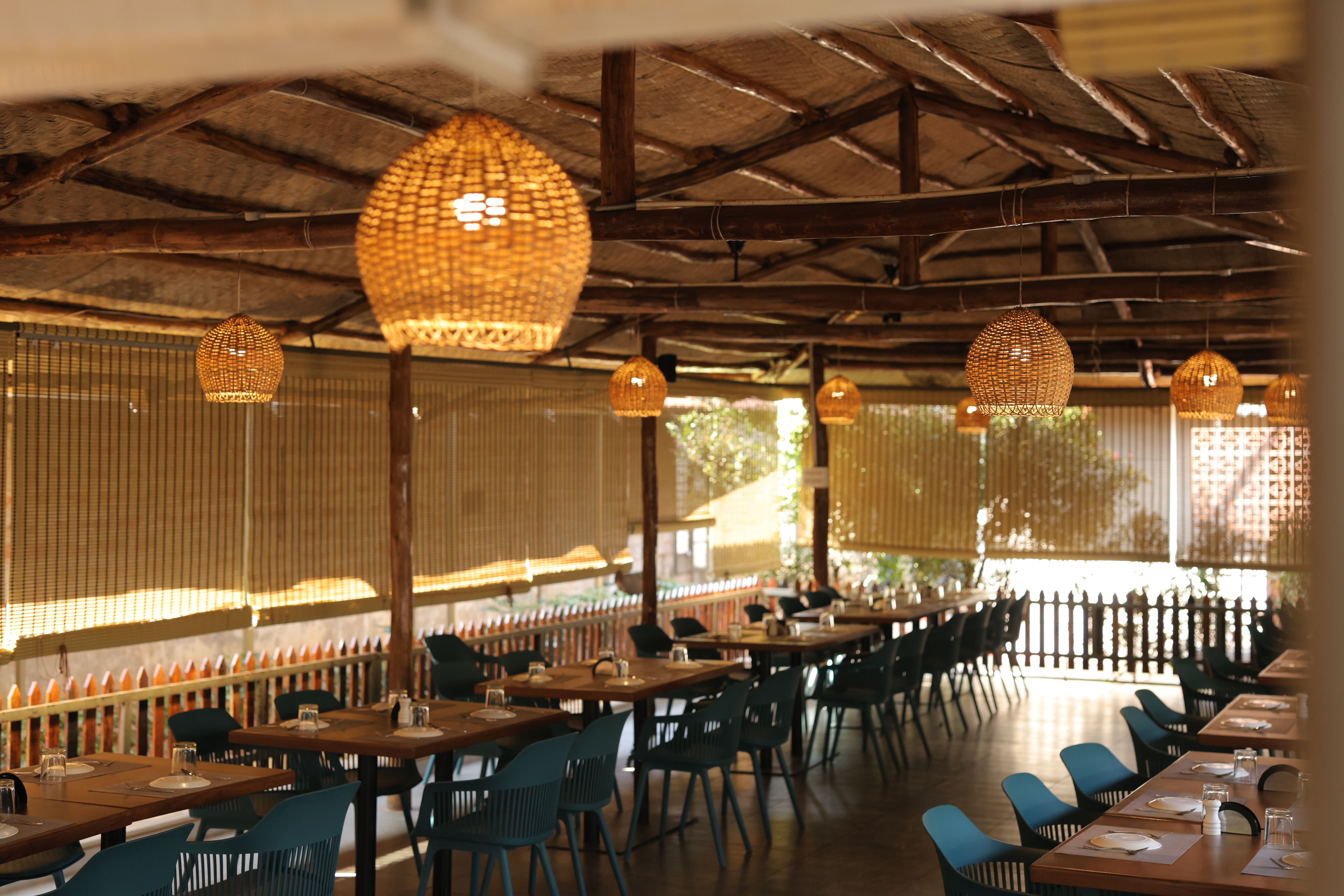 Elegant interior of Jatra Countryside with wicker pendant lights and long dining tables