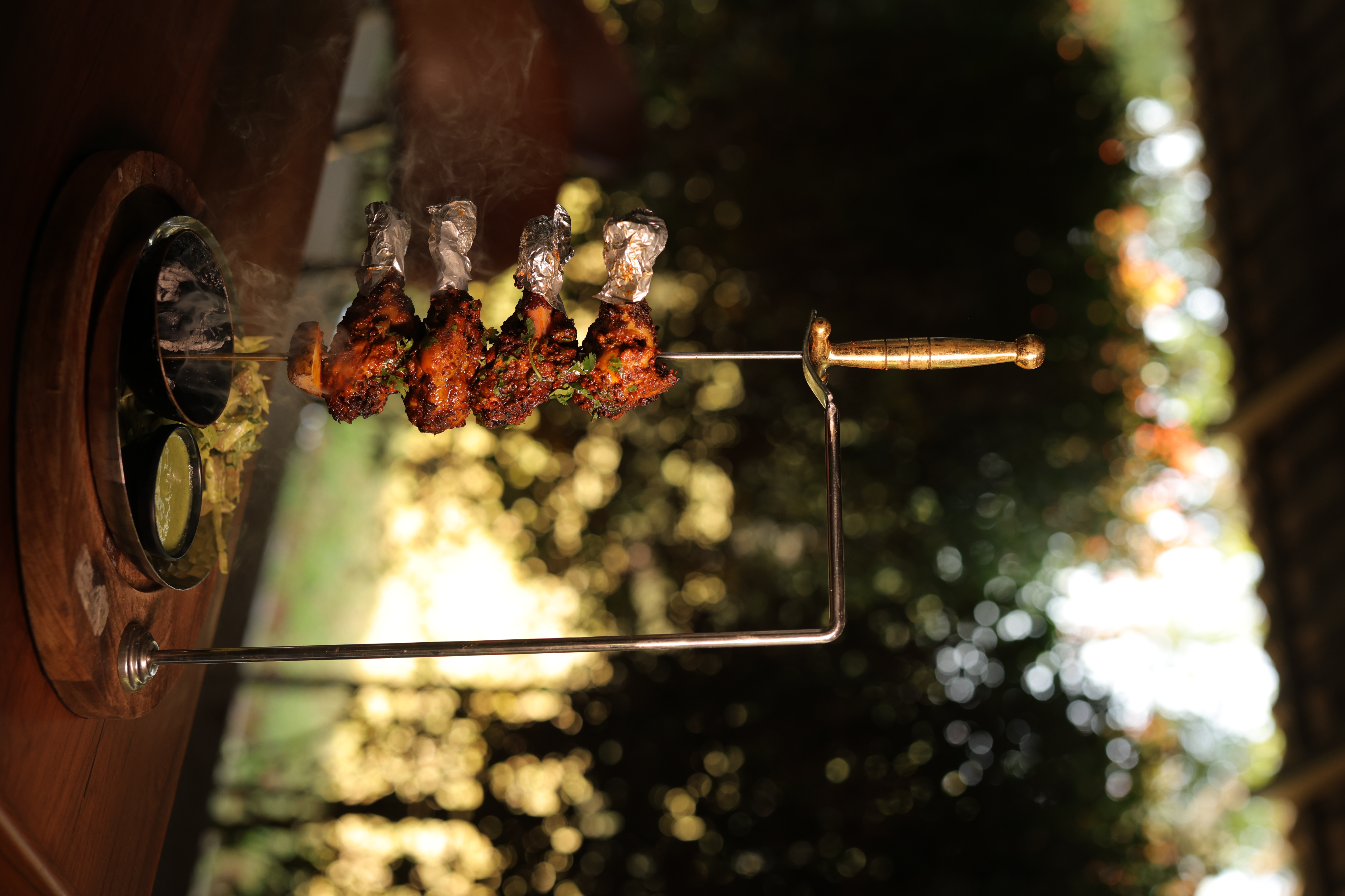 Freshly grilled tandoori chicken on a skewer at Jatra Countryside