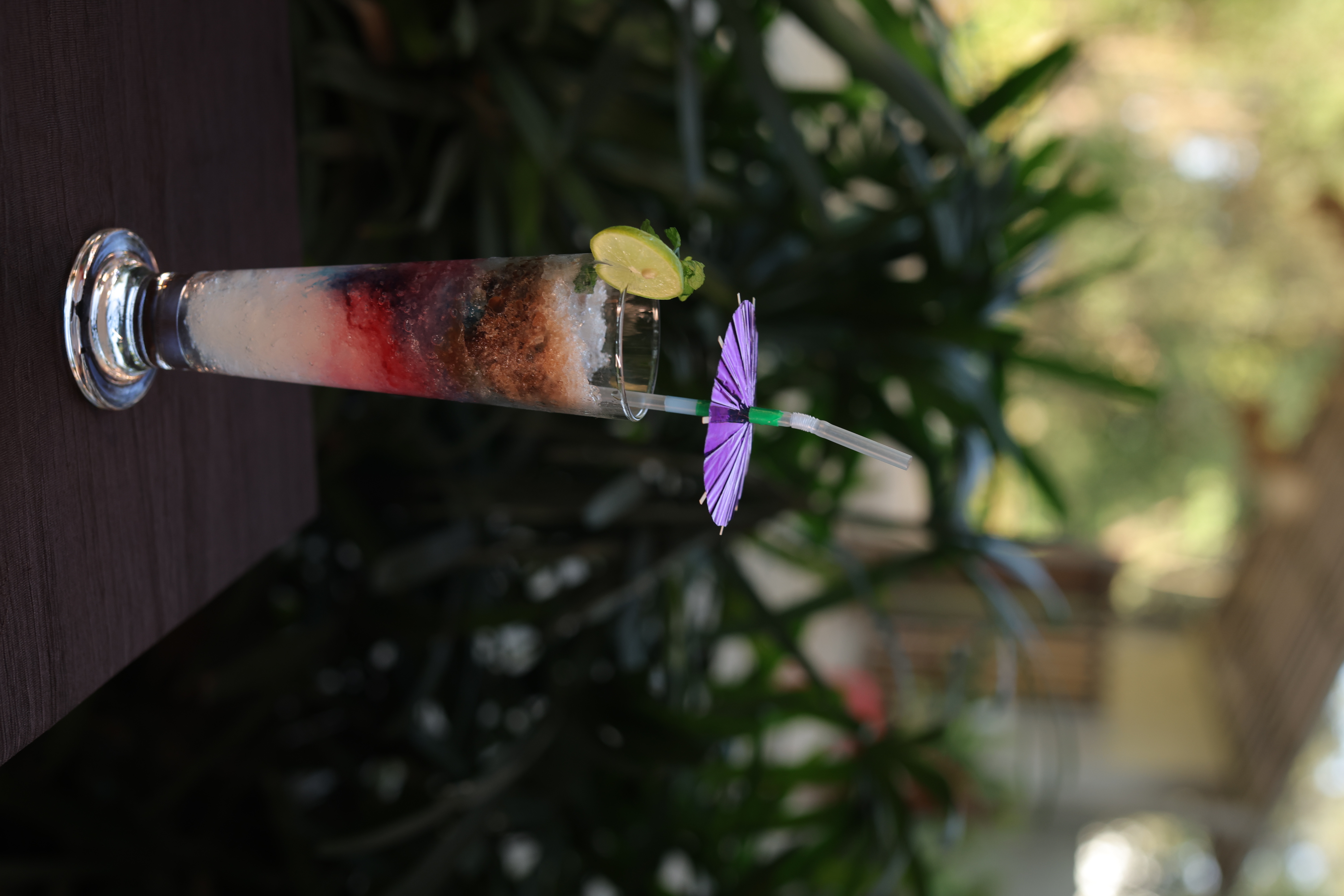 Layered signature mocktail with fruit garnish at Jatra Countryside